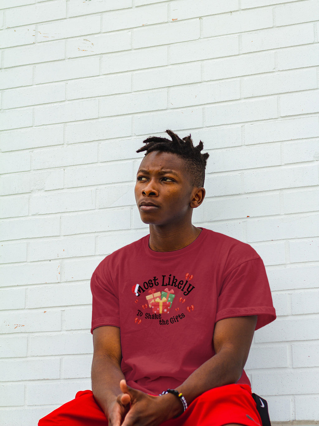 Most Likely to Shake the Gifts Christmas Tee — Fun Unisex Holiday Shirt with Gift & Bow Graphics | LAHall Artworks