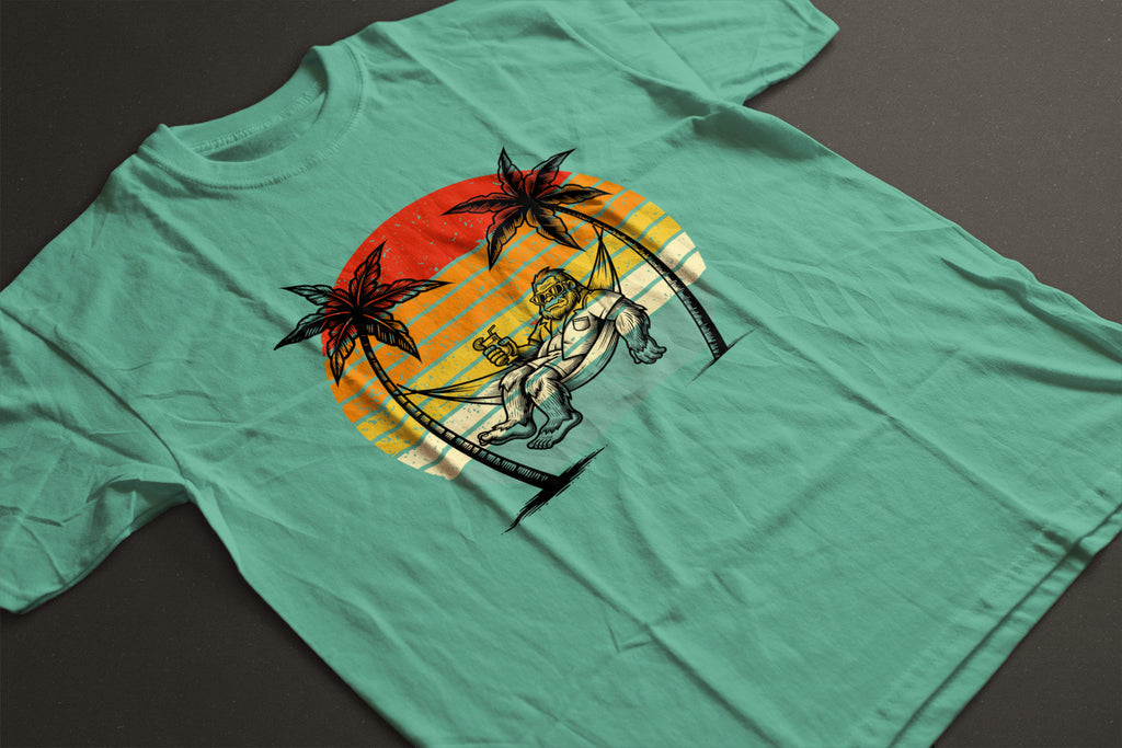 Bigfoot Beach Sunset Graphic Tee – Funny Sasquatch Vacation Shirt | Vintage Retro Summer T-Shirt | LAHall Artworks Bigfoot Collection
